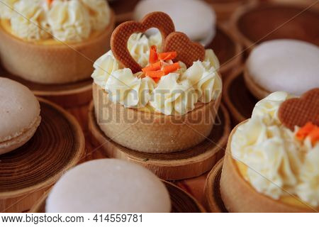 White Delicate Lowly Macaroons On A Wooden Background. The Pastel Tone Of The Cream Inside The Frenc