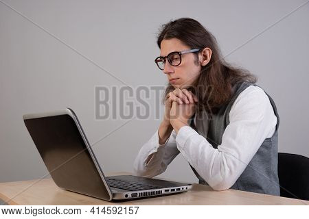 Programming And Application Development, A Young Man Writes Code Sitting At A Laptop.