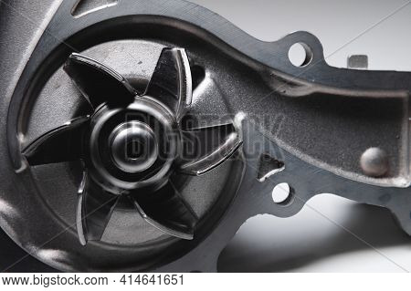Close-up Water Pump Of The Internal Combustion Engine Cooling System. Contrasting On A Gray Gradient