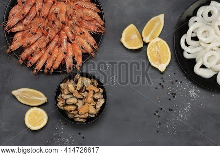 Plates Of Shrimp, Squid Rings And Mussels Isolated On Gray Background.