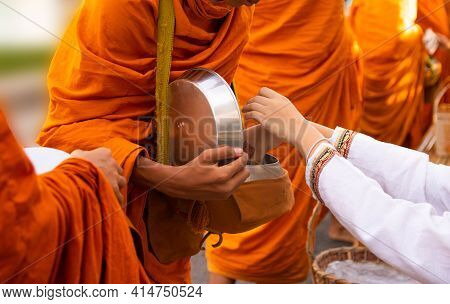 Thai People Are Offering Food To The Monks In The Bowl. On Buddhist Important Days