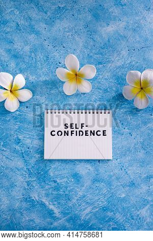Positive Attitude Concept, Self-confidence Text On Notepad With Tropical Flowers Around It
