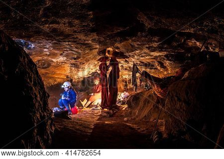 Speleologists Resting In Underground Camp. Exploring Caves Are Dangerous And Caving Is Considered An