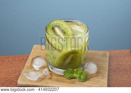 Alcoholic Drink Caipirinha Based On Kiwi And Aguardente Distilled Cocktail Drink And Fruits On Blue 