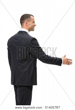 Half-length profile of businessman handshake gesturing, isolated on white. Concept of leadership and success