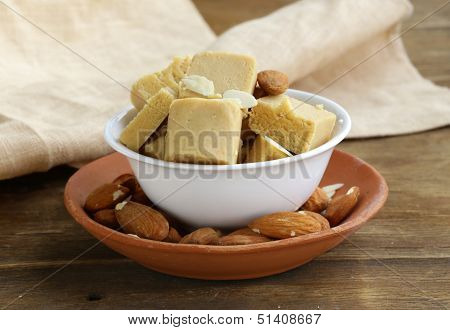 almond paste - marzipan in a bowl with whole nuts