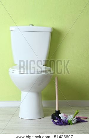 White toilet bowl and cleaner things in a bathroom