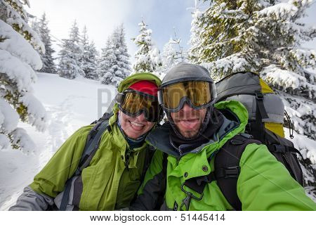 Two Funnny Hikers Posing At Camera In Winter Mountains