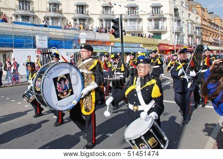 HASTINGS, ENGLAND - AUGUST 10: The Corps of Drums of the Farnborough Royal British Legion parade along the seafront at the annual Old Town Carnival on August 10, 2013 in Hastings, East Sussex.