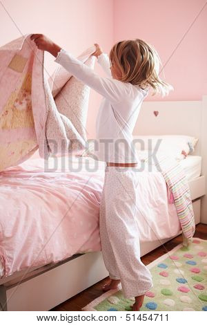 Young Girl Making Her Bed