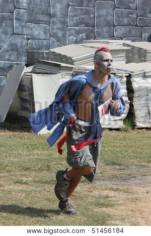 MUSKOGEE, OK - Sept. 14: Zombies attack runners and attempt to grab their red life flags  during the Castle Zombie Run at the Castle of Muskogee in Muskogee, OK on September 14,  2013.