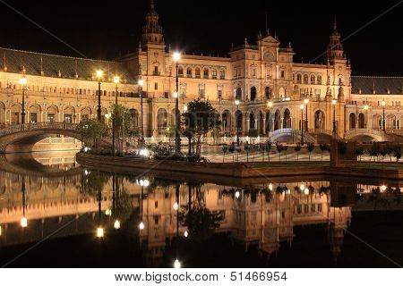 Plaza de Espana in Sevilla at night, Spain. Panoramic reflected in the canal