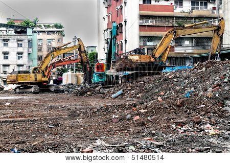 Earthmovers Demolishing Building