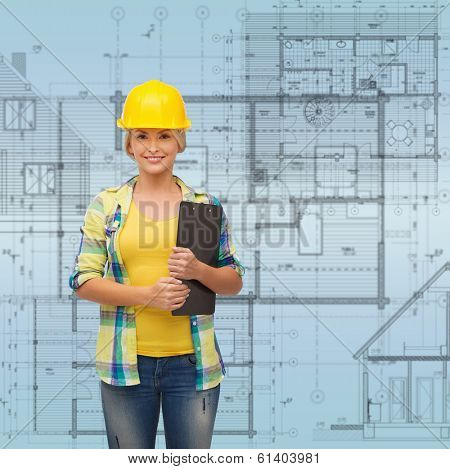 repair, construction and maintenance concept - smiling woman in helmet with clipboard