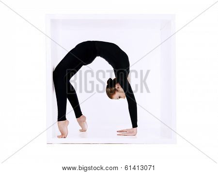 Modern bellet dancer posing with a cube at studio. Plastic body concept. Isolated over white.