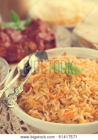 Indian cuisine biryani rice and chicken curry with retro effect.