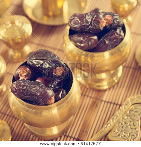 Dried date palm fruits or kurma, ramadan food which eaten in fasting month in retro effect.