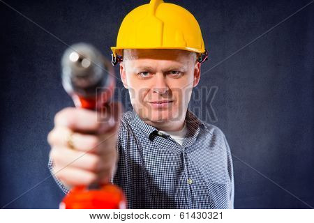 Construction worker holding a drill