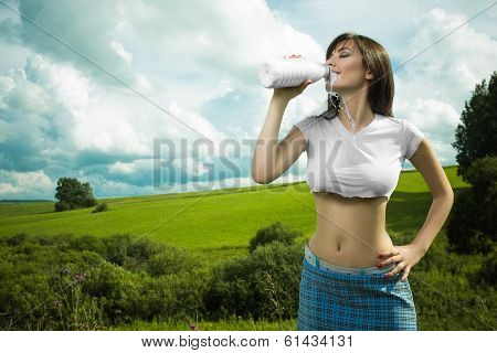 girl in a t-shirt drinking milk.