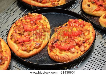 just baked  hot crunchy mini pizzas with cheese and tomato