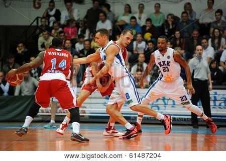 KAPOSVAR, HUNGARY - MARCH 8: Marton Fodor (white 8) in action at a Hungarian Championship basketball game with Kaposvar (white) vs. Paks (red) on March 8, 2014 in Kaposvar, Hungary.