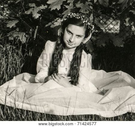ILOWA, POLAND, CIRCA SIXTIES: Vintage photo of little girl with braids at her First Communion