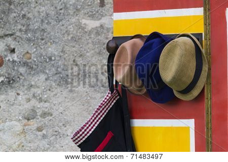 colorful hanger with old hat and umbrella