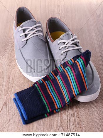 Top-Siders and socks on wooden background