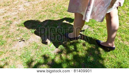 Leg Of Beautiful Girl Walking On The Green