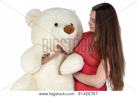 Image of girl looking at teddy bear