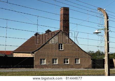 WEIMAR, GERMANY - JUNE 21, 2013: Crematorium and electrified barbed wires in the Buchenwald concentration camp near Weimar, Germany.