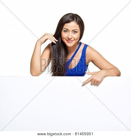 Young pretty woman peeking out from behind the wall