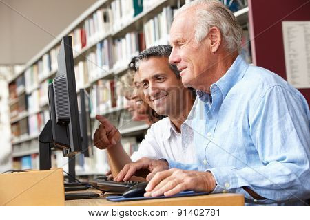 Students working on computers in library
