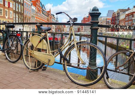 Bicycles Parked Near The Floating Flower Market In Amsterdam