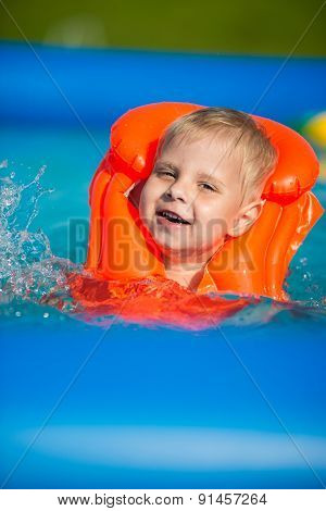 Pretty little boy in swimming pool