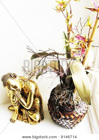 Buddhist Statue with Orchid