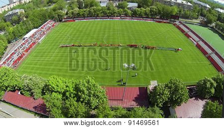 RUSSIA, BOGORODSKOE - MAY 14, 2014: Teams play soccer on field of Spartakovec stadium named by N.P. Starostin during international competition. Aerial view