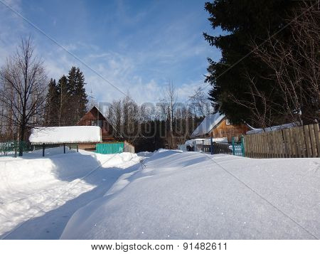 Village in winter sunny day