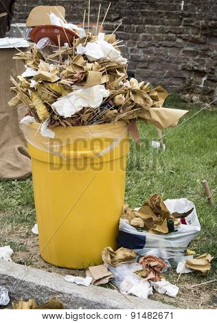 Overfull garbage can trash in festival