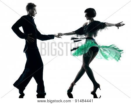 one caucasian elegant couple dancers dancing in studio silhouette isolated on white background