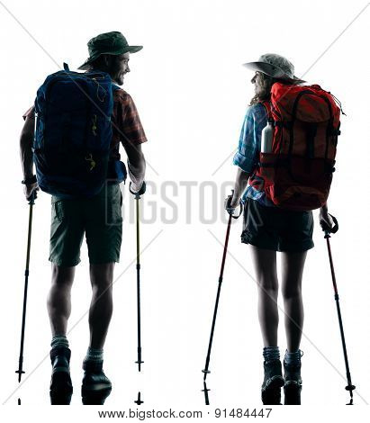one caucasian couple trekker trekking walking nature in silhouette isolated on white background