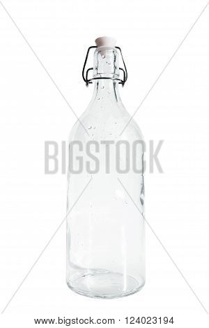 Empty glass bottle with dew drops, isolated on white background