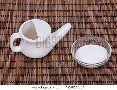 Ceramic neti pot and sea salt in bowl