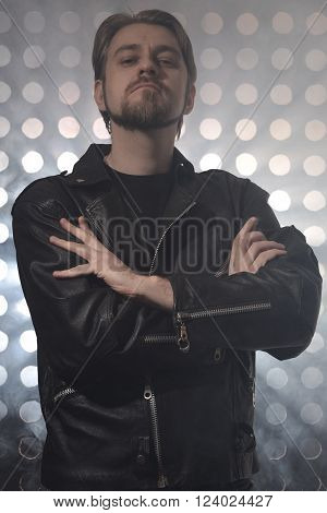 Attractive bearded man in black leather jackets in smoke
