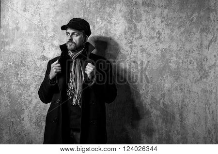 image of a caucasian man with grungy blond hair dressed warmly in a stylish black trench coat and a funky hat and scarf for the cold winter
** Note: Soft Focus at 100%, best at smaller sizes