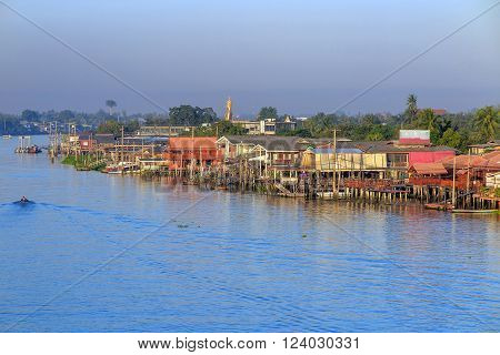 Traditional Riverside village and boat near Bangkok Thailand