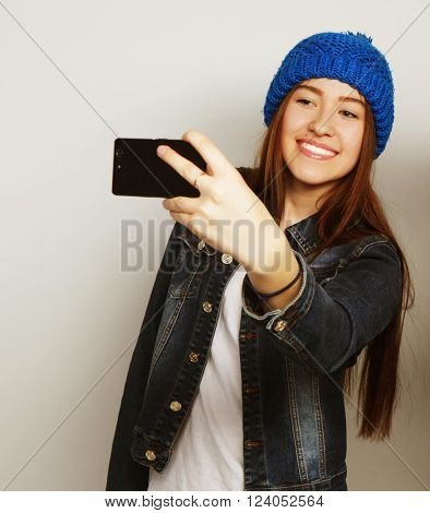 Girl take a self portrait with her smart phone