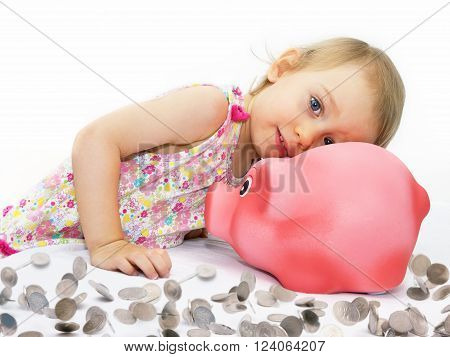 Two-year-girl dreams about what can buy for the money from piggy bank.