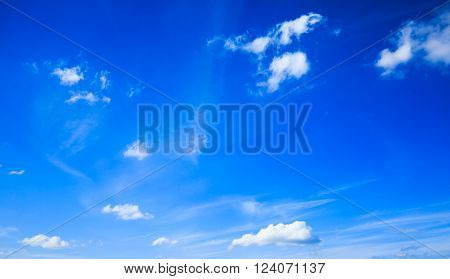 Some small white clouds spreaded over a bright blue sky