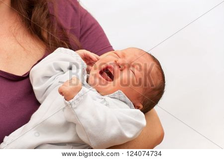 Newborn baby crying in his mother's arm